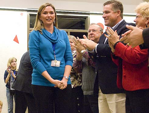 Armand Bayou Elementary School Second-grade teacher Maggie Calagna steps forward to accept a surprise $25,000 Milken Educator Award as Clear Creek Independent School District Superintendent Dr. Greg Smith and other members of the school community applaud.