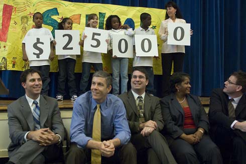 Daniel R. Cameron Elementary School Cameron Elementary students and Milken Family Foundation Trustee Joni Milken-Noah hold up cards displaying the amount of the Milken Educator Award, which is about to go to an unsuspecting teacher at Cameron.  Seated in front of the stage are Cameron Elementary Principal David Kovach and Chicago Public Schools CEO Arne Duncan, along with several local dignitaries.