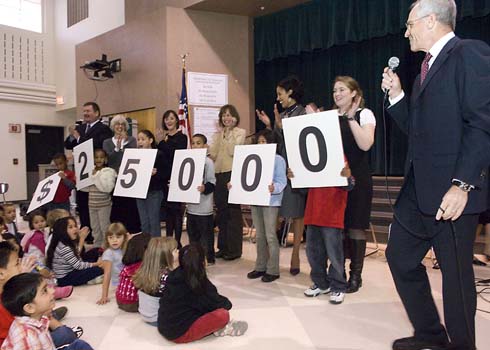 Cascade Elementary School Cascade Elementary students hold up cards displaying the amount of the Milken Educator Award as Milken Family Foundation Executive Vice President Richard Sandler prepares to announce the recipient of that amount.  'And that educator is...'