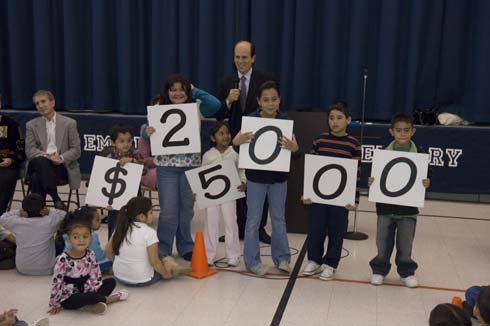 Empire Elementary School Students at Empire Elementary School hold up cards displaying the amount of the Milken Educator Award, which is about to go to one of their outstanding, unsuspecting educators.