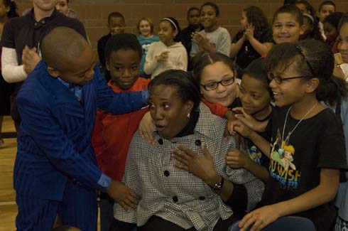 Fontenelle Elementary School Students surround their still-stunned teacher Crystal Simpson to congratulate her on being honored with a $25,000 Milken Educator Award.