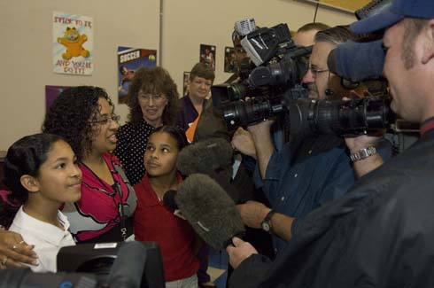 Horace Mann Dual Language Magnet School Vanessa Martinez speaks to local TV news crews about what it was like to be surprised with a $25,000 Milken Educator Award.