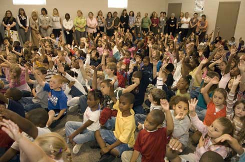Horn Lake Elementary School Horn Lake Elementary students raise their hands, hoping to be called on to help Dr. Jane Foley answer a question.