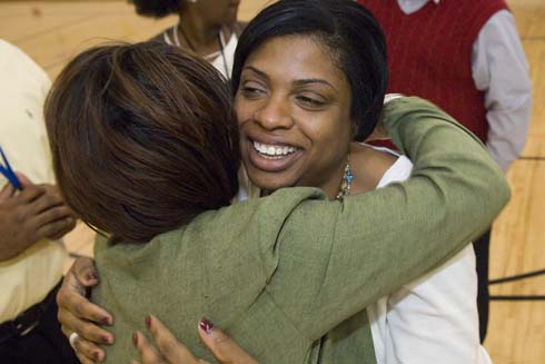 Nellie Stone Johnson Community School Kelly Woods gets a congratulatory hug after being surprised with a $25,000 Milken Educator Award.