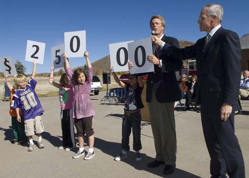 McPolin Elementary School As McPolin students hold up cards displaying the amount of the Milken Educator Award, McPolin Principal Bob Edmiston announces the name of the recipient, with a little help from Milken Family Foundation Executive Vice President Richard Sandler.