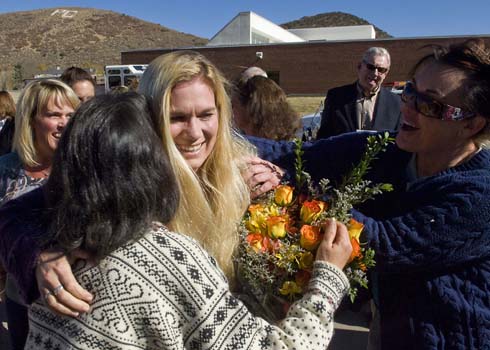 McPolin Elementary School Colleagues surround teacher Melissa Bott to hug and congratulate her on her $25,000 Milken Educator Award.