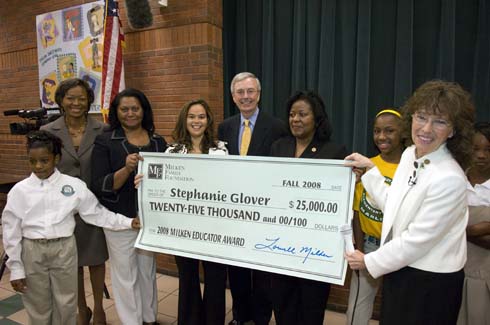 Thelma Smiley Morris Elementary School Stephanie Glover (fourth from left) stands behind an oversized check representing her Milken Educator Award.  Also in the photo:  Morris Elementary Principal Sophia Johnson (second from left), Alabama State Superintendent of Education Joseph Morton (center) and Dr. Jane Foley, senior vice president, Milken Educator Awards (far right)