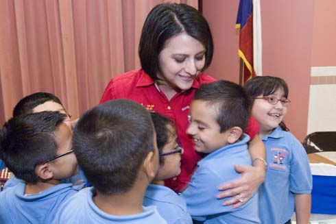 North Alamo Elementary School New Milken Educator Claudia Peña is surrounded by her students.