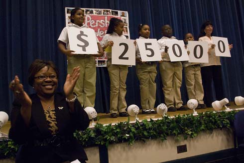 John J. Pershing West Magnet School Pershing Principal Cheryl Watkins smiles as students from her school hold up cards displaying the amount of the Milken Educator Award, which will go to an unsuspecting educator at their school.  And the Award goes to...