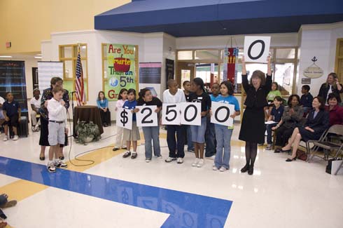 Sawyer Road Elementary School Sawyer Road students—with help from Milken Educator Awards Senior Vice President Dr. Jane Foley holding up the last zero—display the amount of the Milken Educator Award, which is about to go to one of their unsuspecting teachers.