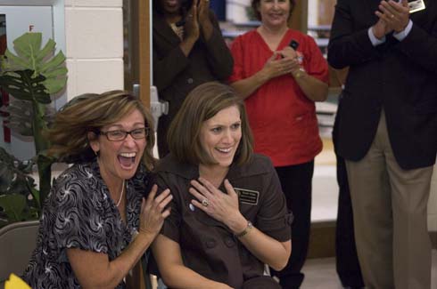 Sawyer Road Elementary School A colleague rejoices with a stunned Susan Grigg moments after she is surprised with a $25,000 Milken Educator Award.
