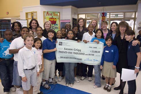 Sawyer Road Elementary School Susan Grigg (center) stands with students, colleagues and special guests behind an oversized check representing her Milken Educator Award.