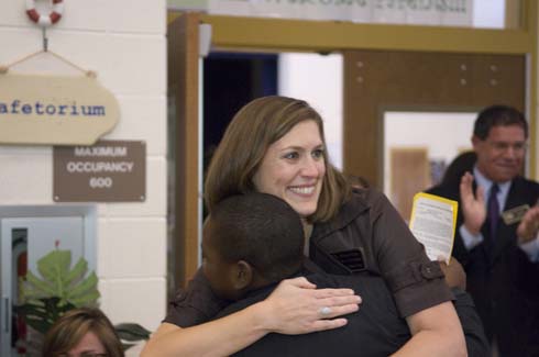 Sawyer Road Elementary School A student congratulates new Milken Educator Susan Grigg with a hug.