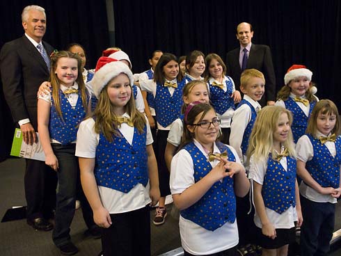 C.T. Sewell Elementary School U.S. Senator John Ensign of Nevada and Milken Family Foundation Co-Founder Michael Milken stand with the Sewell Elementary Choir as they kick off their schoolwide assembly with song.