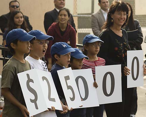 Solano Avenue Elementary School Solano Avenue Elementary students and Milken Family Foundation Trustee Joni Milken-Noah hold up cards displaying the total amount of the Milken Educator Award, which is about to be presented to one of their outstanding teachers.
