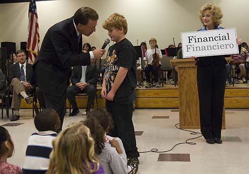 Valley Elementary School Milken Family Foundation Chairman Lowell Milken asks a Valley Elementary student to define the word displayed on the card held up by Foundation Vice President Bonnie Somers.