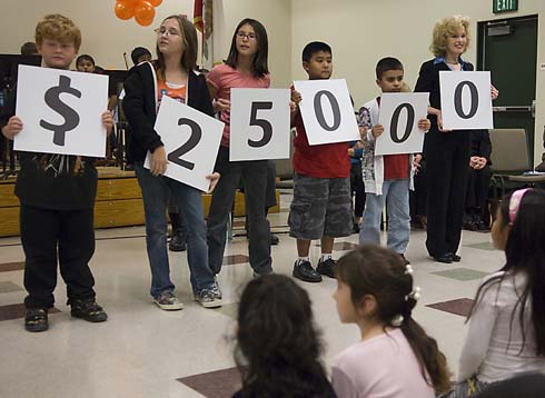 Valley Elementary School Valley Elementary students hold up cards displaying the amount of the Milken Educator Award, which is about to be presented to an unsuspecting educator at their school.