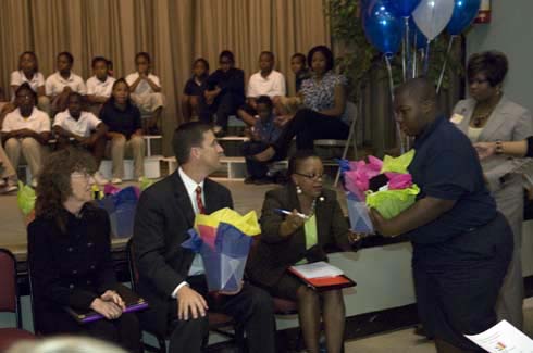 F. B. Woodley Elementary School Dr. Jane Foley, senior vice president of the Milken Educator Awards, and Dr. Hank Bounds, Mississippi state superintendent of education, are presented with gifts by a student at F. B. Woodley Elementary.