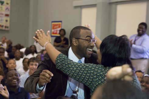 F. B. Woodley Elementary School An ecstatic Aaron Wilson is congratulated by a colleague on his surprise $25,000 Milken Educator Award.