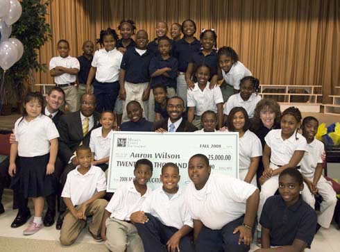 F. B. Woodley Elementary School New Milken Educator Aaron Wilson (center) with his students.  Also in the photo: Mississippi State Superintendent of Education Dr. Hank M. Bounds (second from left) and Milken Educator Awards Senior Vice President Dr. Jane Foley (third from right)