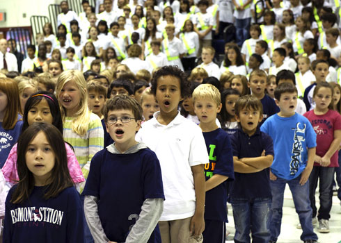 Sean Griffin Notification Students at Belmont Station Elementary School sing the school anthem, 'Heal the World,' to commence the special assembly.